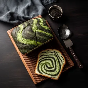 The bread is a fluffy, milk bread with a beautiful green and black swirl throughout. When sliced, you can see the intricate design of the two colors woven throughout the bread. It's perfect for toast or sandwiches.